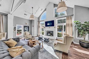 A living room with a couch and chairs and a fireplace